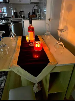 a table with a bottle of wine and candles on it at Luxury 2-Bedroom Suite at Bear Mountain Victoria in Langford