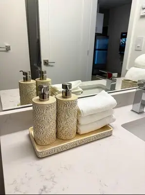 a bathroom with three towels and a mirror at Luxury 2-Bedroom Suite at Bear Mountain Victoria in Langford