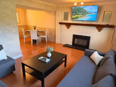 a living room with a couch and a fireplace at Spacious 2 Bedroom Suite in Delta