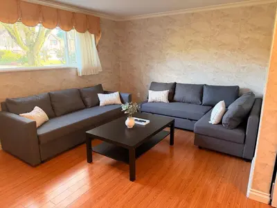 a living room with a couch and a coffee table at Spacious 2 Bedroom Suite in Delta