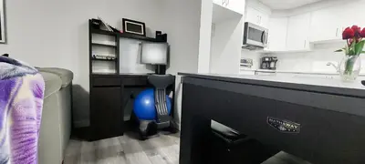 a kitchen with a desk with a blue ball in a room at Cozy Luxe 1BR Suite in Calgary