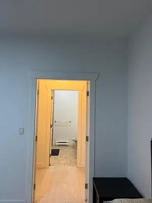 a hallway with a door leading to a bathroom at 2 Bedroom plus den 2 Bathroom apartment in Surrey