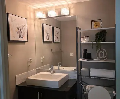 a bathroom with a sink and a mirror at SkyHaven Urban Condo near YYC Airport in Calgary