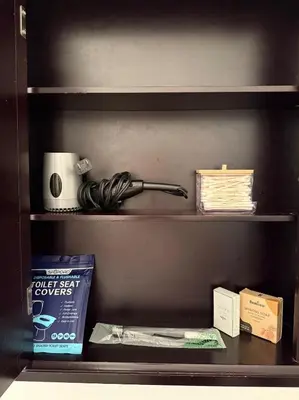 a book shelf with a lamp and other items on it at Private 1BR, AC, Strong Wi-Fi, Netflix and Amazon Prime in Victoria