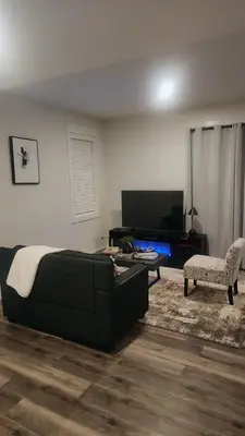 a living room with a bed and a couch at Hebzibah's Luxe in Prince George