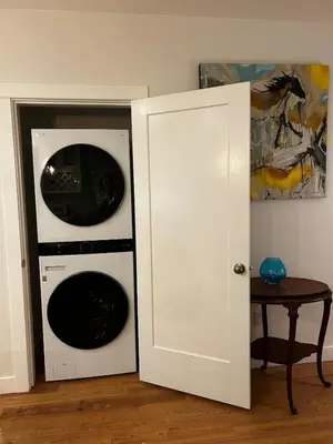 a washer and dryer in a room with a door at Retreat to Quail Cottage in Chemainus