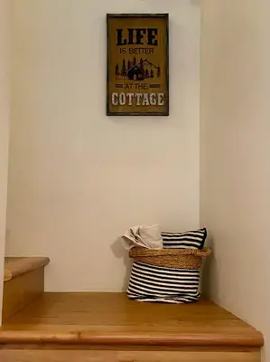 a wooden bench with a picture on the wall at Retreat to Quail Cottage in Chemainus