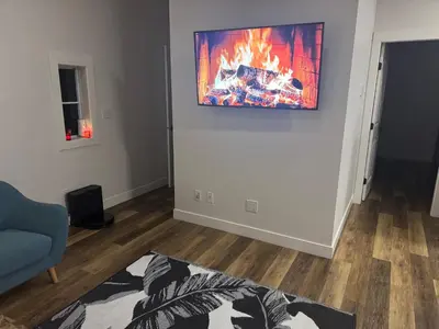 a living room with a fire on the wall at Next rental in Vernon