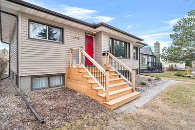a home with a wooden staircase leading to a red door at Modern House-3BR/Spacious good for 8/Free Parking in Edmonton