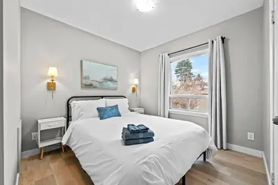 a bedroom with a large white bed and a window at Modern House-3BR/Spacious good for 8/Free Parking in Edmonton