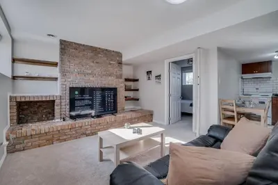 a living room with a couch and a fireplace at Edmonton House w/5BR/3BA/2Kitchens & Fenced Yard in Edmonton