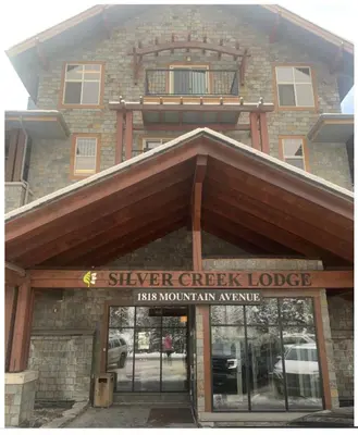 a building with a sign that reads silver creek lodge at Canmore Mountain View in Canmore