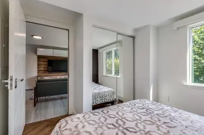 a bedroom with a bed and a mirror at Luxury 2BR Walk to Everything Downtown in Vancouver