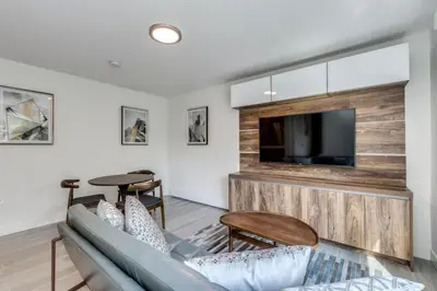 a living room with a couch and a flat screen tv at Luxury 2BR Walk to Everything Downtown in Vancouver