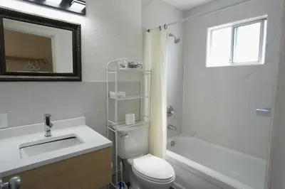 a white bathroom with a toilet and a sink at Park Motel in Hope