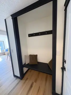 a large mirror in a living room with a shelf at Charming Mission Downtown Condo in Calgary