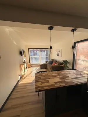 a living room with a couch and a table at Charming Mission Downtown Condo in Calgary