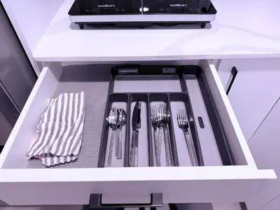 a drawer with utensils in a kitchen at Cozy Haven 2 in Bélanger