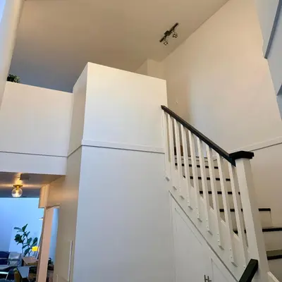 a staircase in a house with white walls at City Line Views w Rooftop Patio in Vancouver
