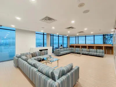 a large room with couches and tables and windows at Gastown Unbeatable View 1 Bedroom High Floor Condo Rooftop View of Downtown in Vancouver
