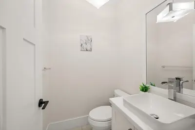 a white bathroom with a toilet and a sink at Your Next Stay Spacious Bright & Sophisticated in Vancouver