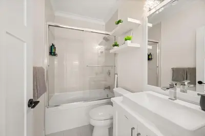 a white bathroom with a toilet and a sink at Your Next Stay Spacious Bright & Sophisticated in Vancouver