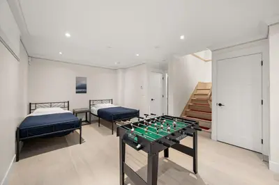 a room with two beds and a foosball table at Your Next Stay Spacious Bright & Sophisticated in Vancouver