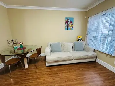 a living room with a couch and a glass table at Moon rooms in Vancouver