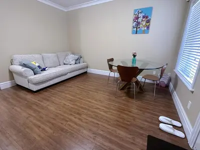 a living room with a couch and a glass table at Moon rooms in Vancouver