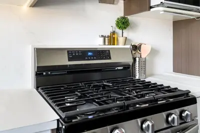 a black stove top oven in a kitchen at Modern Vancouver Private Room-15 Mins to Downtown in Vancouver