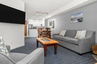 a living room with a couch and a table at Ski-in and Out Lake Placid Lodge in Whistler