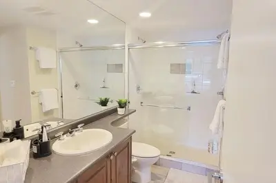 a bathroom with a sink and a shower and a toilet at Heart of Whistler Village, Mountain Views, Pool & Hot Tub in Whistler
