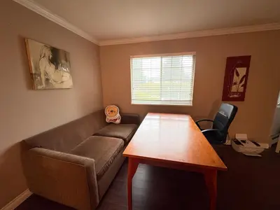 a living room with a couch and a table at Nordel Way Guest House - Walk to Transit & Shopping - 20 Min to YVR in Surrey