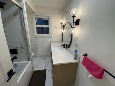 a bathroom with a sink and a shower and a mirror at Downtown Vancouver Cozy Room - Near SkyTrain, BC Place & Free Parking in Vancouver