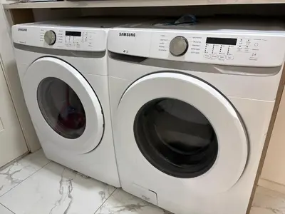 two washing machines are sitting next to each other at Downtown Vancouver Cozy Room - Near SkyTrain, BC Place & Free Parking in Vancouver