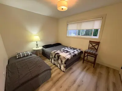 a bedroom with two beds and a window at Downtown Vancouver Cozy Room - Near SkyTrain, BC Place & Free Parking in Vancouver
