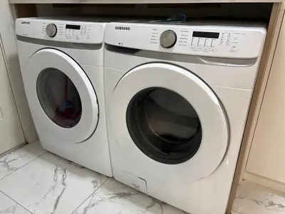 two white washing machines sitting next to each other at Downtown Vancouver Cozy Room - Near SkyTrain, BC Place & Free Parking in Vancouver