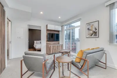 a living room with a couch and a table at Upscale 1BR2BA Walk Everywhere in Vancouver