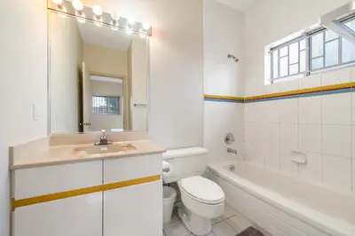 a bathroom with a sink and a toilet and a tub at Cozy & Modern Room near Langara & Downtown in Vancouver