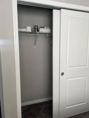 a closet with a white door and a shelf at Spacious Private Room with TV, WiFi and Fridge in Edmonton