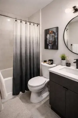 a bathroom with a toilet and a sink and a mirror at Royal Bay Guest Suite in Victoria