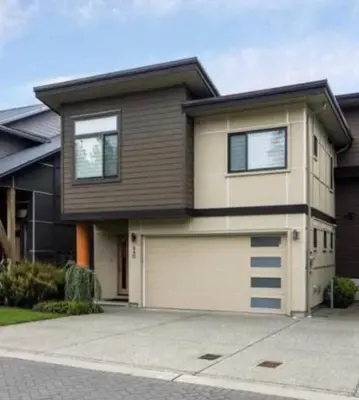 a large house with a garage in front of it at Royal Bay Guest Suite in Victoria