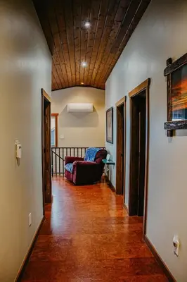 a living room with a couch and a wooden ceiling at Big Bear Chalet and spa in Revelstoke