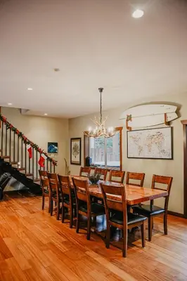 a dining room with a wooden table and chairs at Big Bear Chalet and spa in Revelstoke
