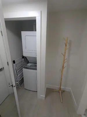 a bathroom with a toilet in a small room at Greystone Retreat - Walk to River & Downtown in Cochrane