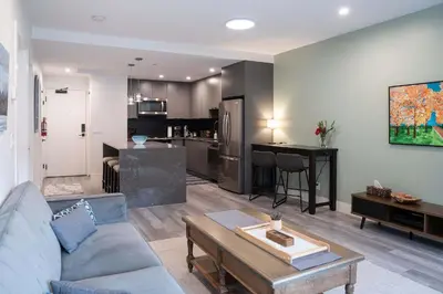 a living room with a couch and a table at Tu Casa - 2 Bedroom Condo with Private Hot tub in Revelstoke