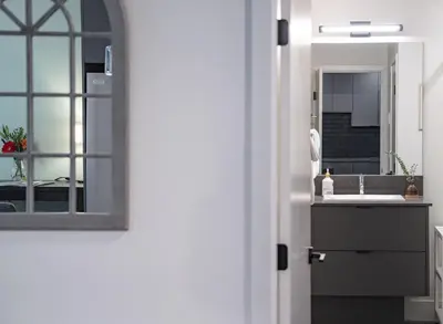a kitchen with a sink and a mirror at Tu Casa - 2 Bedroom Condo with Private Hot tub in Revelstoke