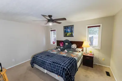 a bedroom with a bed with a teddy bear on it at Bright 3BR Upper Suit, 23 min to Jasper NP in Hinton