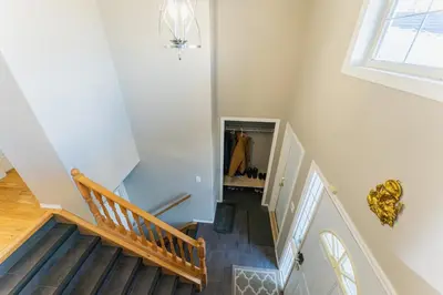 a hallway with stairs and a mirror in a house at Bright 3BR Upper Suit, 23 min to Jasper NP in Hinton