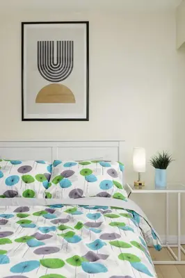 a bedroom with a bed with blue and green umbrellas at The Forest Pedal House in Squamish